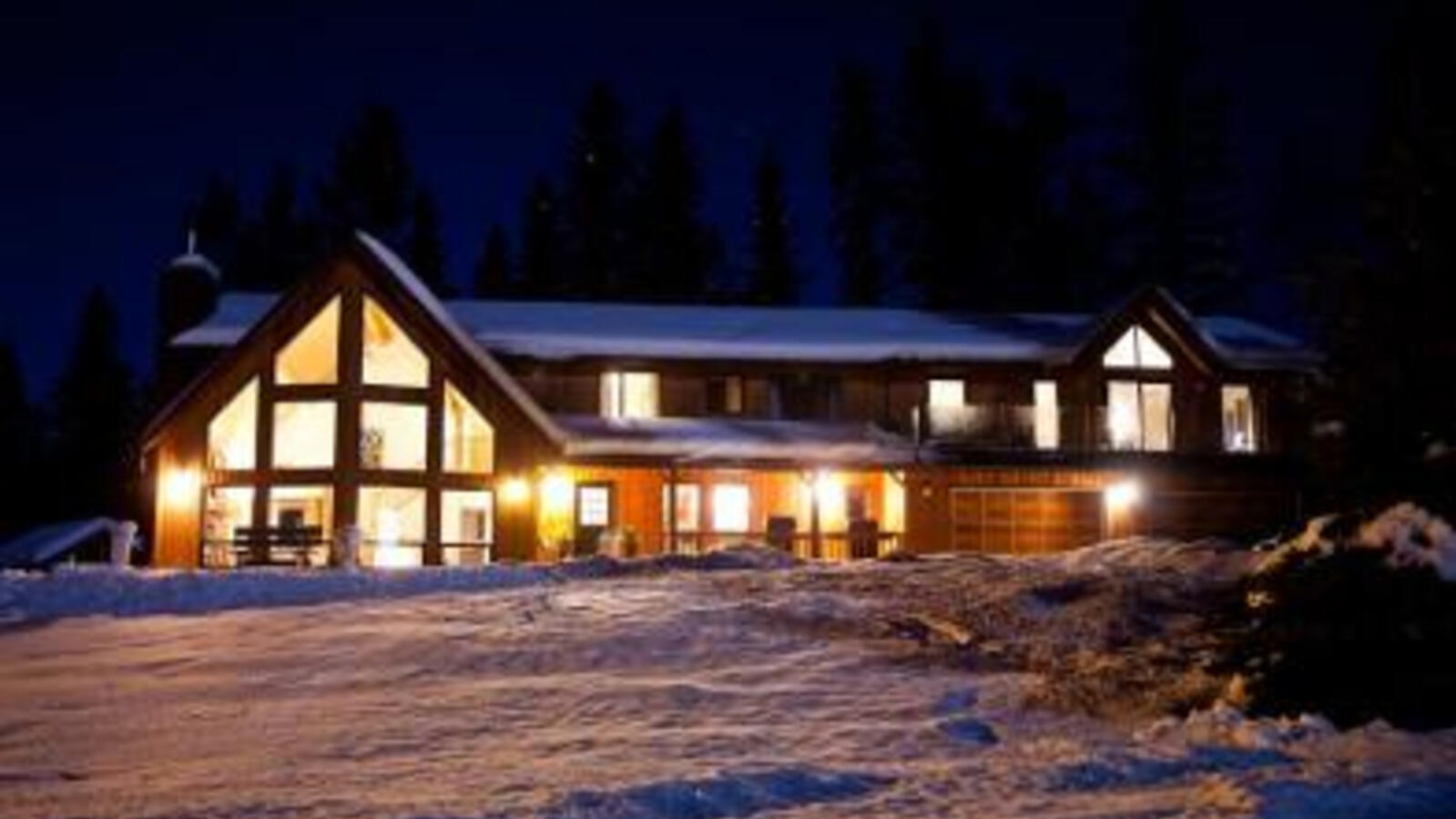 Extérieur du Home Lodge Golden BC de nuit dans la neige hivernale.  